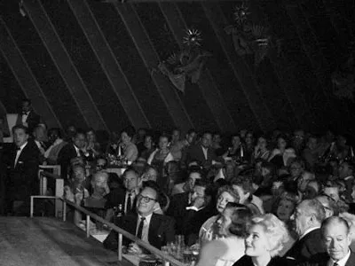 Frank Sinatra singing on the stage of the Sands Hotel.