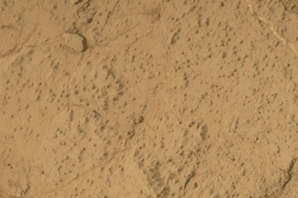a gif shows martian ground followed by a hole drilled into it and surrounded by dust
