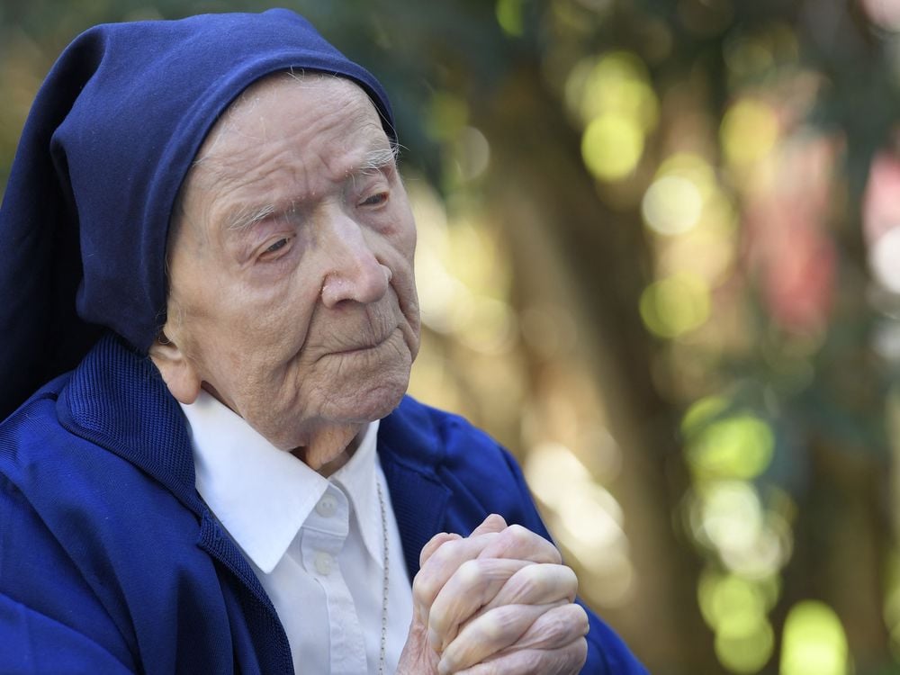 Sister Andre, Lucile Randon in the registry of birth, the eldest French and European citizen, prays in a wheelchair, on the eve of her 117th birthday