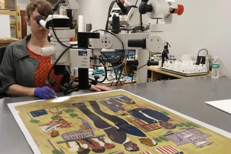 Keara Teeter treating William H. Johnson’s Historical Scene with Mary McLeod Bethune, ca. 1945, oil on paperboard