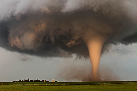 A tornado churns up dust at dusk near Traer, Iowa.