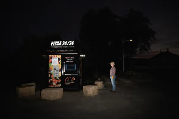 Loneliness in the countryside. Pizza machine and a man. thumbnail