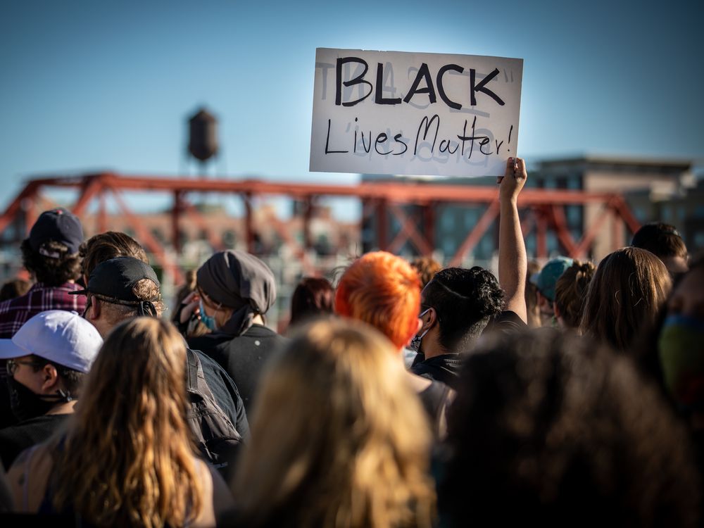 Group of protesters during black lives matter marches holding a black lives matter sign
