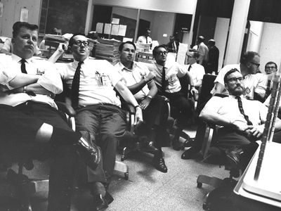 John Newcomb (fourth from left) and other members of the Lunar Orbiter team watch the first Earthrise picture come in, August 1966.