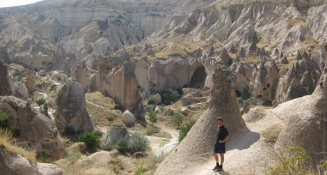 The author stands amidst weirdness in the Cappadocian village of Zelve.