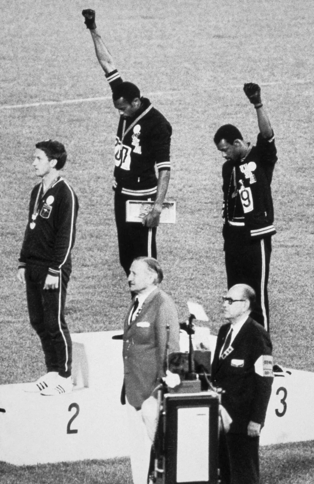 Athletes Tommie Smith (center) and John Carlos (right) raise clenched fists during the medal ceremony for the 200-meter dash at the 1968 Summer Olympics in Mexico City.