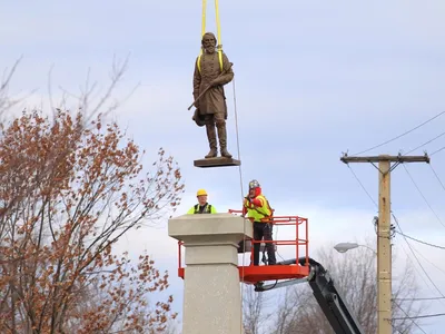 Workers removing the statue of Ambrose P. Hill from its pedestal in Richmond, Virginia, on December 12