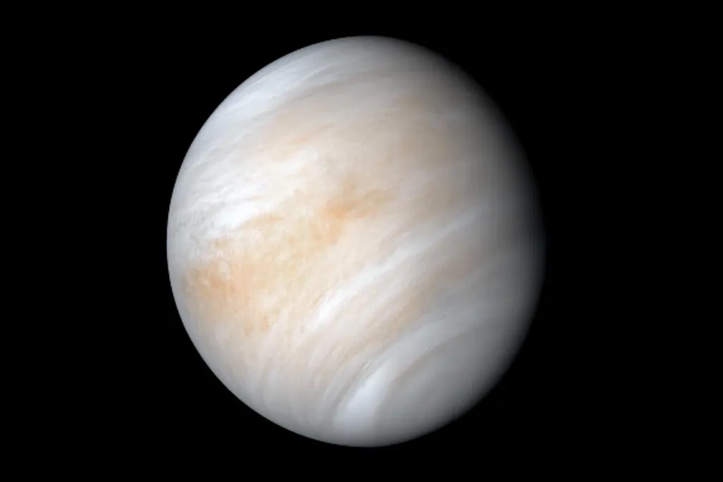 Venus, a ball of swirling light brown, white and grey, framed against a jet black background