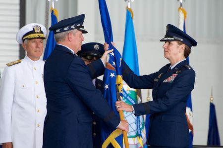 General Robinson, right, is handed the Pacific Air Forces flag during a ceremony yesterday.