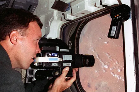 Dom Gorie looks out Discovery's window in 1998.