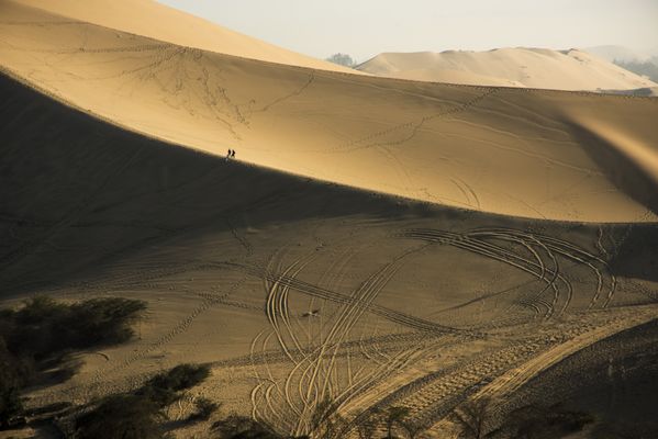 People walking in the dunes of Ica Peru thumbnail