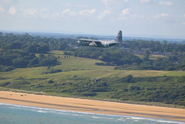 A Texas ANG 136 AW C-130J flying overhead OMAHA beach in Normandy (France) thumbnail