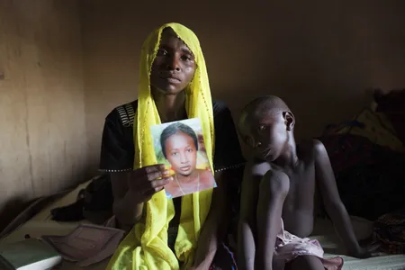 Rachel Daniel, mother of one of the abducted Nigerian school girls, holds up a picture of her still-missing daughter. 