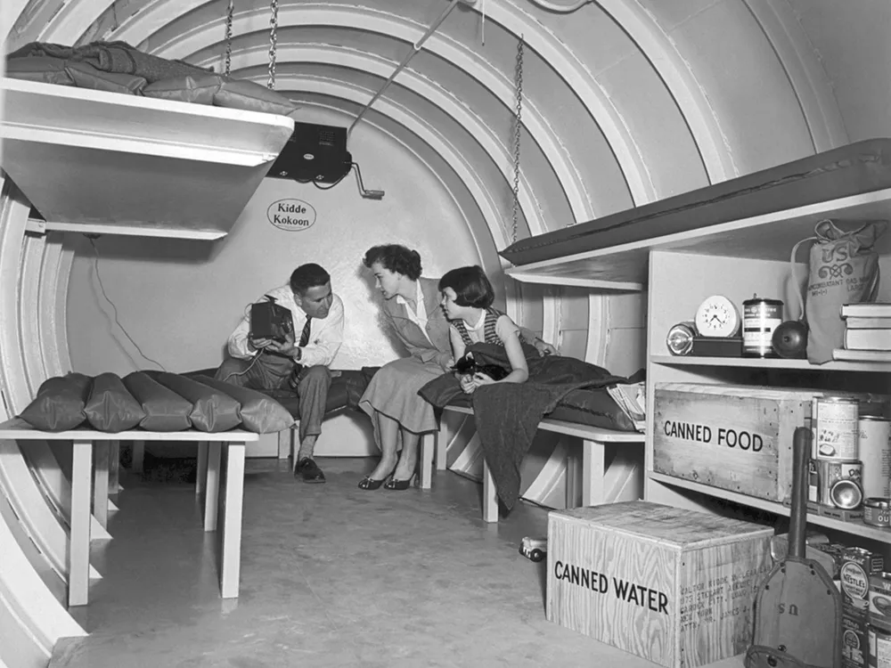 A Long Island family sits in a "Kidde Kokoon" underground bomb shelter in 1955.