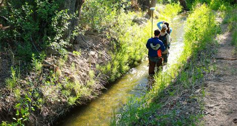 Drylands design students walking a ditch in the Embudo Valley