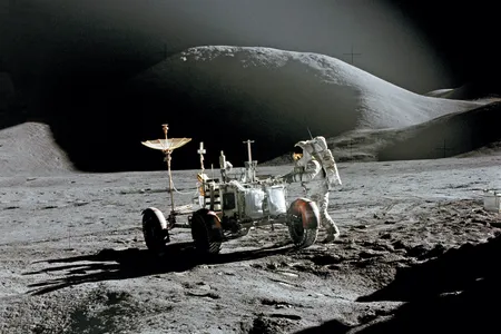 Toward the end of their first day outside, Dave Scott captured this dramatic shot of Jim Irwin and the rover, with Mt. Hadley’s summit in the background, 
12 miles away.