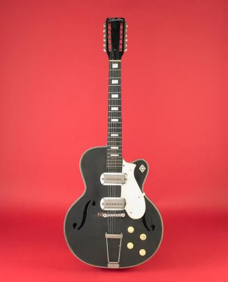 Black and white guitar against red background