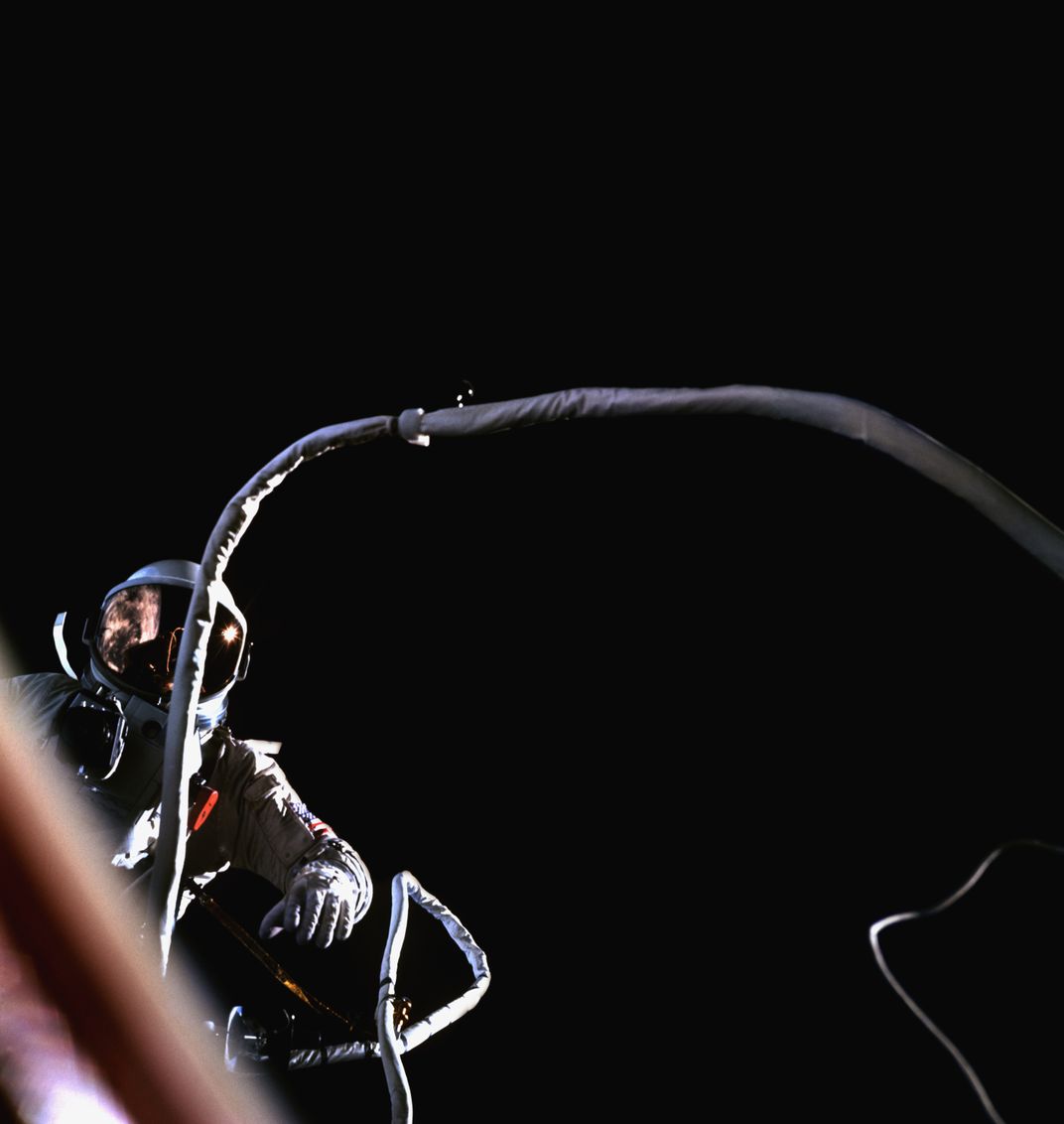 Astronaut Gene Cernan tethered to the Gemini 9 spacecraft as it orbits the Earth
