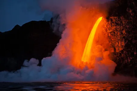 Kilauea at sunrise: A massive flow streams from a lava tube at the Kamokuna ocean entry.