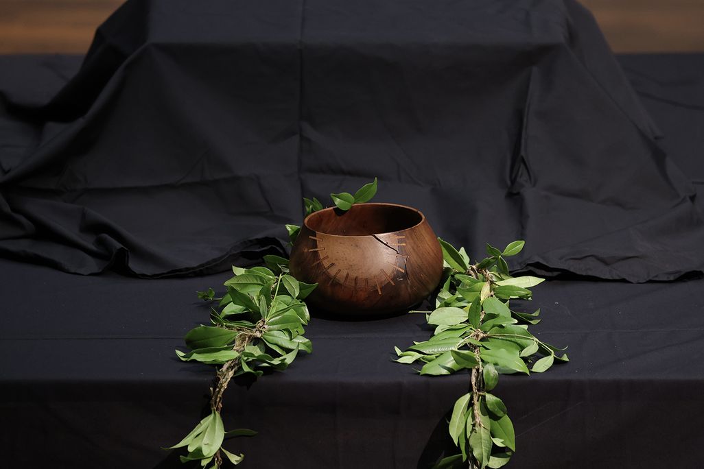 Covered in black cloth, a box containing human remains sits on a table during a repatriation ceremony in Berlin on February 11, 2022