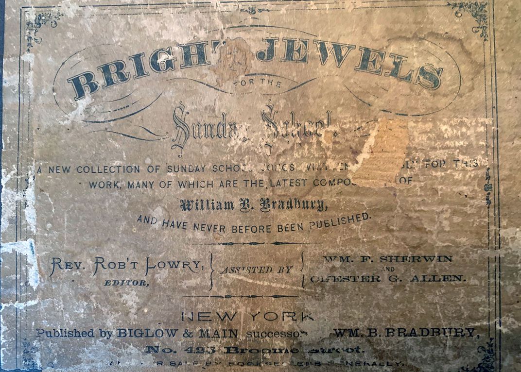 Worn cover of a book, titled Bright Jewels for the Sunday School. Rev. Rob't Lowry, Editor.