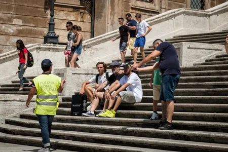A Police officer asks tourists to scoot.