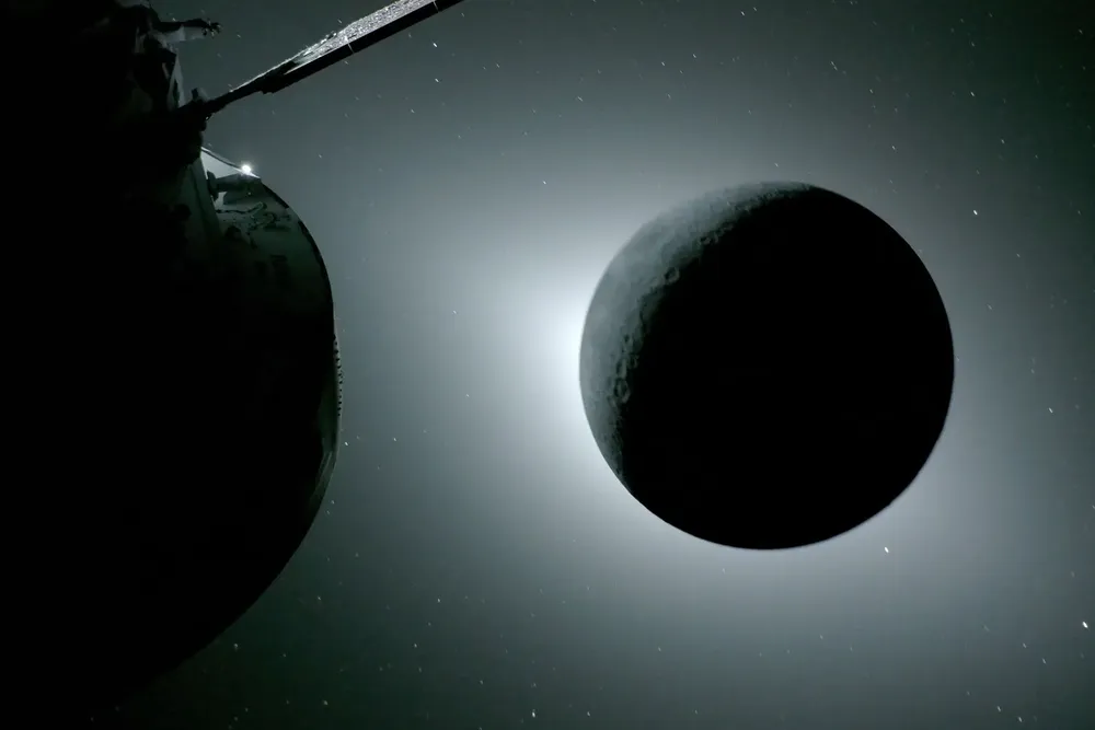 in the foreground at the left is part of the Orion spacecraft. on the right, a dark moon eclipses the sun, shrouded in a faint white glow