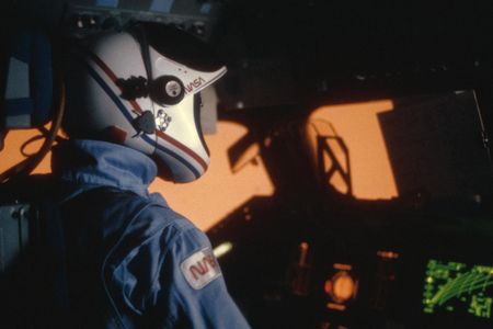 The air outside space shuttle Challenger’s window glows a hot pink-orange during reentry of the STS-41G flight in 1984.