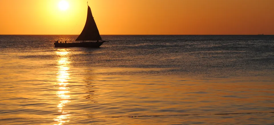  Sunset with traditional <i>dhou</i> on the water off Zanzibar's Stone Town 
