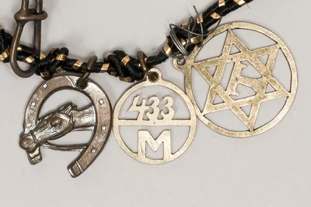 These charms are among the 20 found on a bracelet donated by Holocaust survivor Greta Perlman