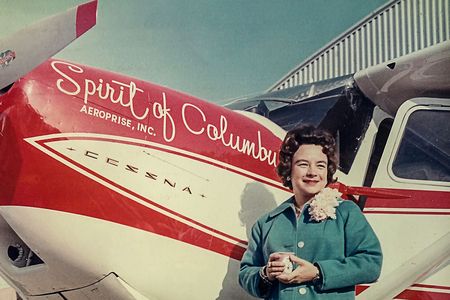 Moments before she took off from the Port of Columbus Airport on her 1964 flight, Mock posed in front of Three-Eight Charlie, also known as the Spirit of Columbus. According to her memoir, Mock wore her “blue, drip-dry outfit” throughout the flight.