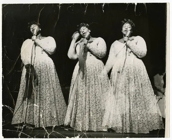 Three images of Ella Fitzgerald, side by side. Her eyes are closed as she sings into the microphone she is holding in front of her.