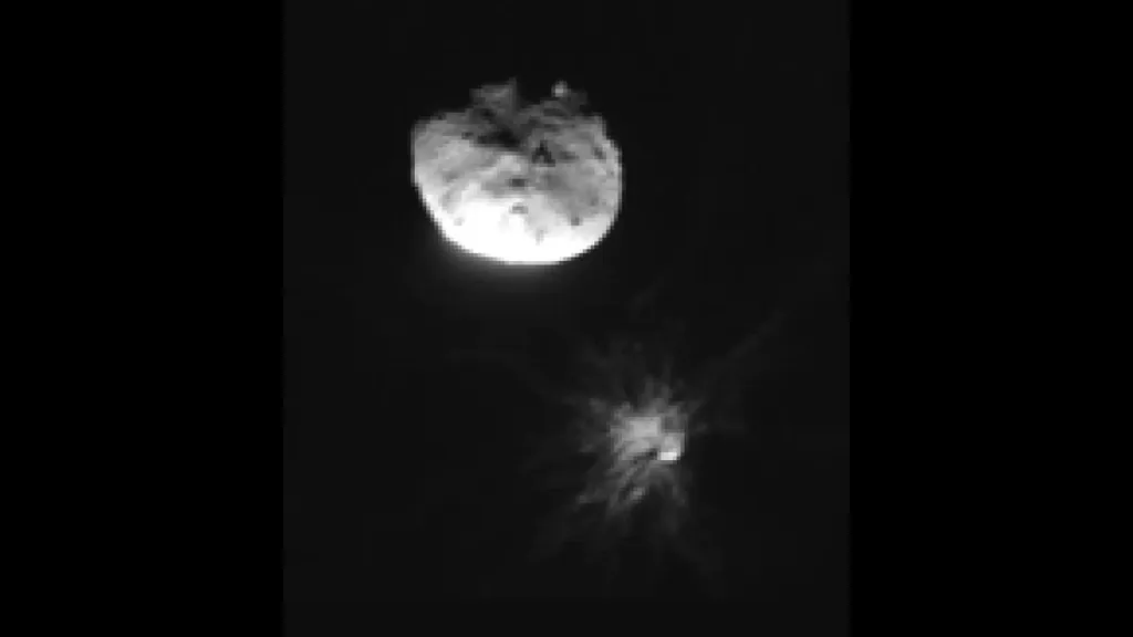 debris fanning out of  an asteroid in space