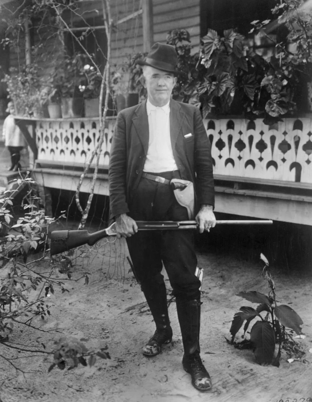 Sheriff Bob Walker holding a shotgun reportedly used by Sylvester Carrier