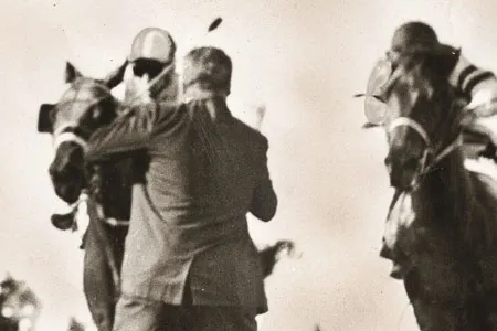 In 1966, Henry Carfagna, the Suffolk Downs track photographer, prepared to take his standard picture of the horses driving toward the wire when he saw a man run onto the track.