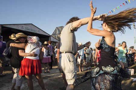 Revelers two-step at the New Orleans Jazz & Heritage Festival.
