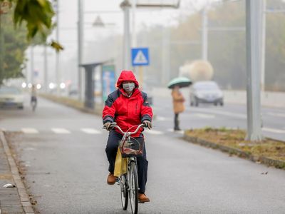 A cyclist braves Beijing's smog with a face mask last month. 