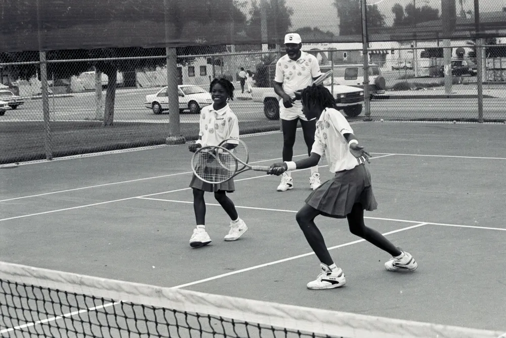 Serena, Venus and their father on the tennis court