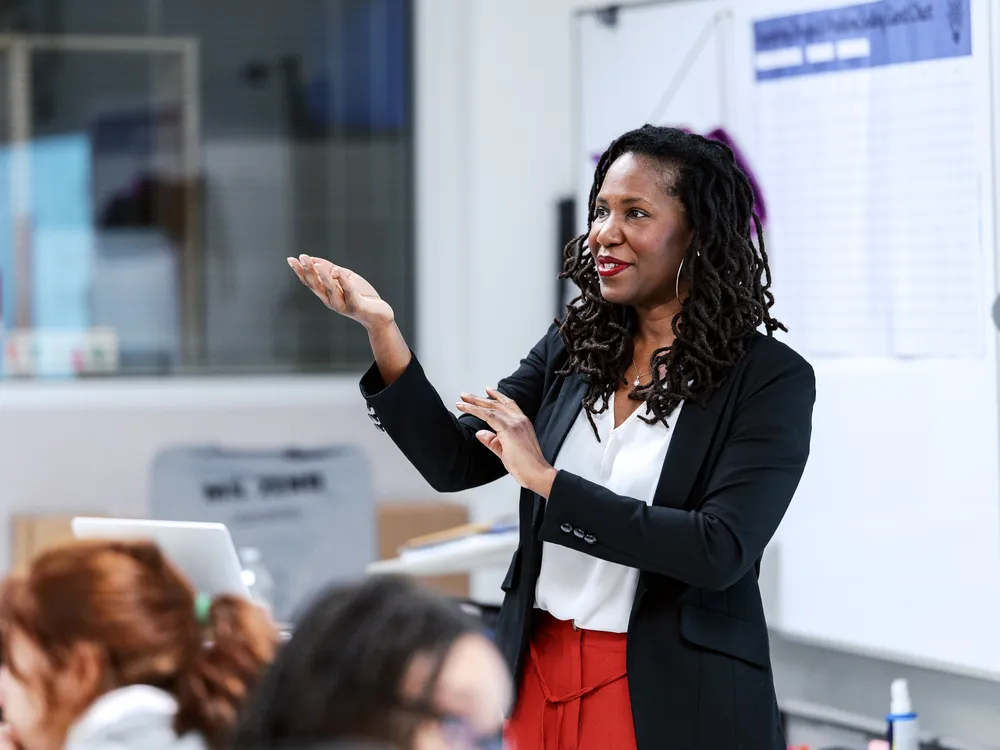 Summer Hamilton stands in front of a classroom gesturing.