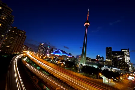 More than 1,800 feet high, the CN Tower, a communications hub and tourist attraction, pierces the night sky just after dusk in downtown Toronto.