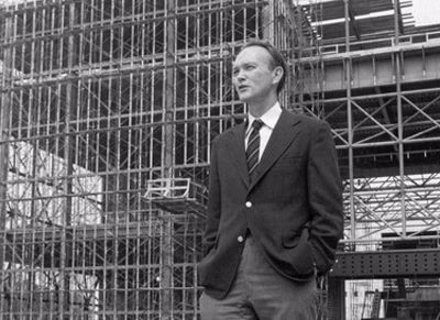 Michael Collins stands in front of the steel skeleton of the new National Air and Space Museum in July 1974