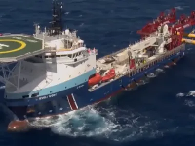 Italian ship the Ievoli Ivory aids the effort to raise a sunken ship that carried migrants