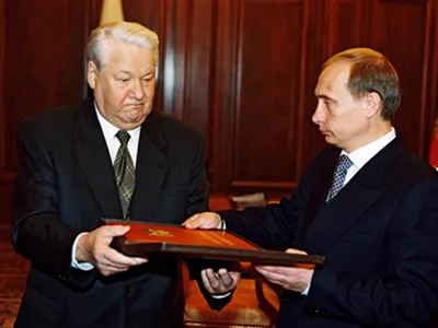President Boris Yeltsin hands over a copy of the Russian constitution to Vladimir Putin, December 21, 1999. 