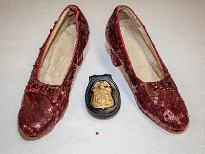 A Minnesota man has been indicted in connection with the 2005 theft of a pair of Judy Garland&#39;s ruby slippers, seen here when they were recovered in 2018, along with the single red sequin that was left at the scene of the crime.