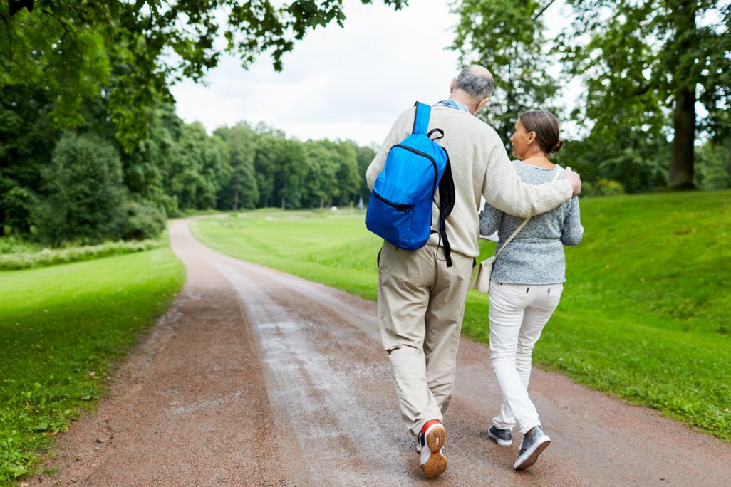 an older couple waking down a path