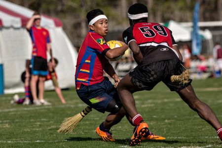 Players from the University of Sydney and McGill University grapple over the quaffle during the 2014 Quidditch World Cup in Myrtle Beach, South Carolina