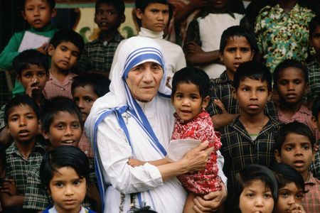 Mother Teresa stands with children at her Calcutta mission.