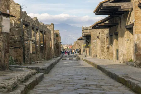 Tourists walk along the Via dell&#39;Abbondanza, one of&nbsp;Pompeii&#39;s major streets.