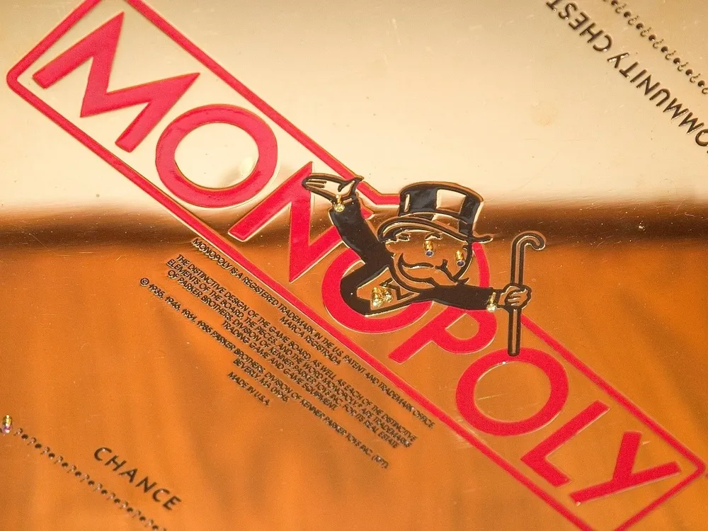 Artist and Jeweler Sidney Mobell donated his gold-plated Monopoly set to the National Museum of Natural History in 2002. (Smithsonian Institution)