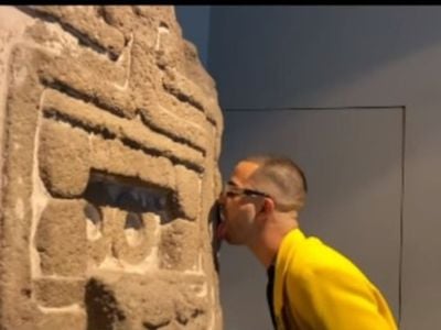 In a screenshot from a short video posted to Instagram, performance artist Pepx Romero licks a work of ancient art at Mexico City&#39;s Museo Nacional de Antropolog&iacute;a.&nbsp;